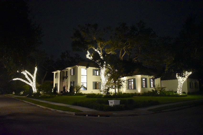 Lights adorn the trees around a home at 1582 South Drive.