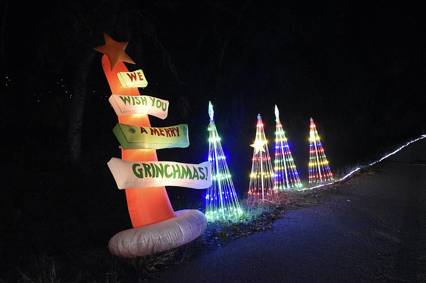 A sign wishes a Merry Grinchmas at 3059 Jamaica Street.