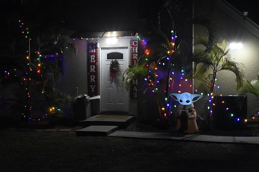 Grogu wishes passerby a happy holiday season at 4511 Groveland Avenue.