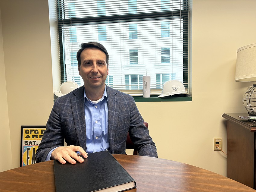 Downtown Investment Authority CEO Colin Tarbert in his office at City Hall. The executive has collected some items, but has yet to decorate his office.