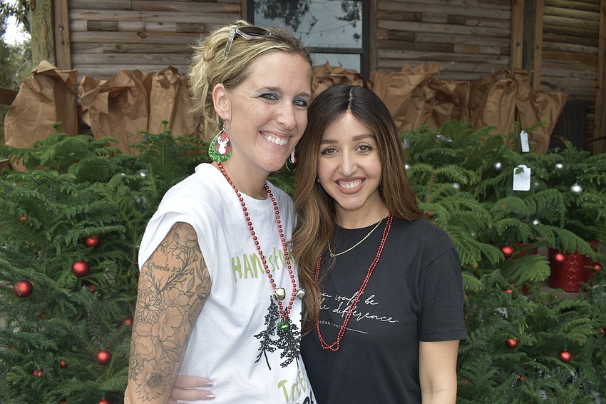 Hannah Morris poses with Hannah Reid during the tree giveaway event on Dec. 6.
