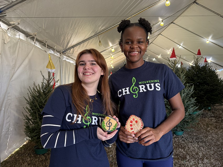 Windermere High School choir students Kemi Agbelusi and Beatriz Bellodi are pining for real trees after working at the tree lot supporting their choir program. The bottom of each tree stump is cut off and turned into a keepsake ornament.