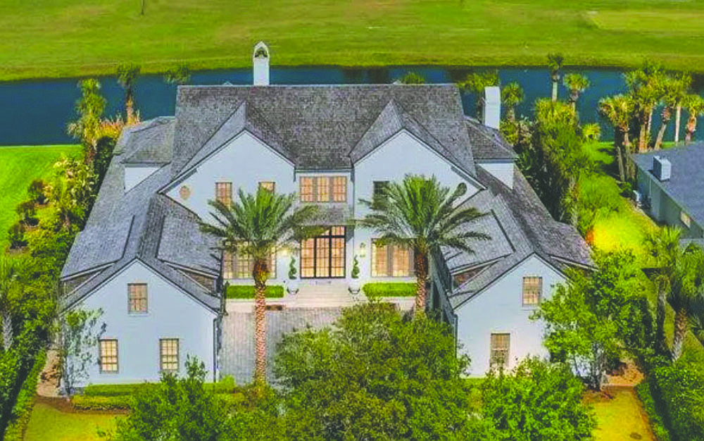 Lakefront with golf view home features seven bedrooms, seven full and three half-bathrooms, porches, wine cellar, outdoor kitchen, pool and four-car garage.