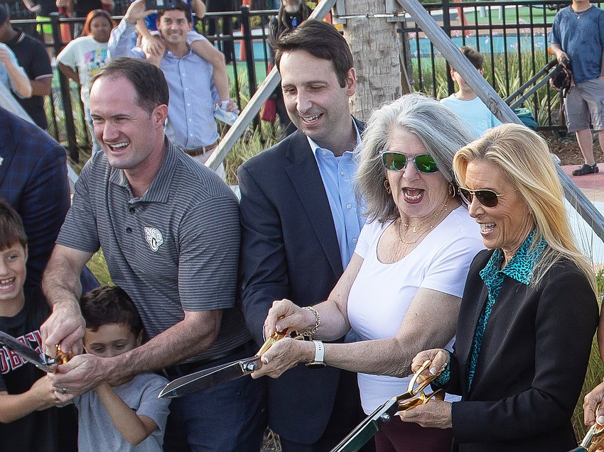 Downtown Investment Authority CEO Colin Tarbert helps cut the ribbon Nov. 24 at the RiversEdge public parks on the Downtown Southbank. Right of Tarbert are his predecessor, Lori Boyer, and Jacksonville Mayor Donna Deegan. At Tarbert's left is City Council member Joe Carlucci.