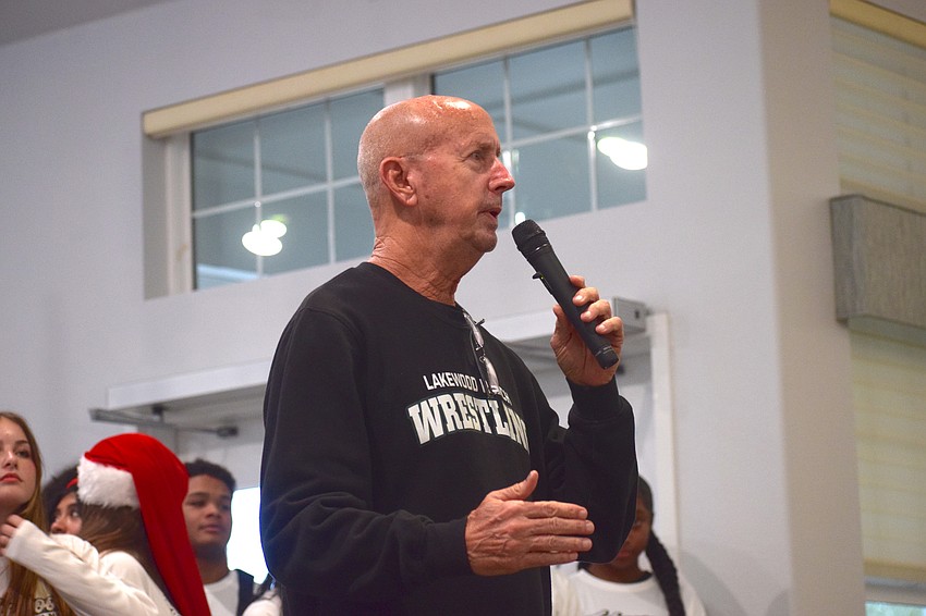 Lakewood Ranch boys wrestling coach Pat Ancil speaks to the crowd of retirees before the Mustangs begin their performance.