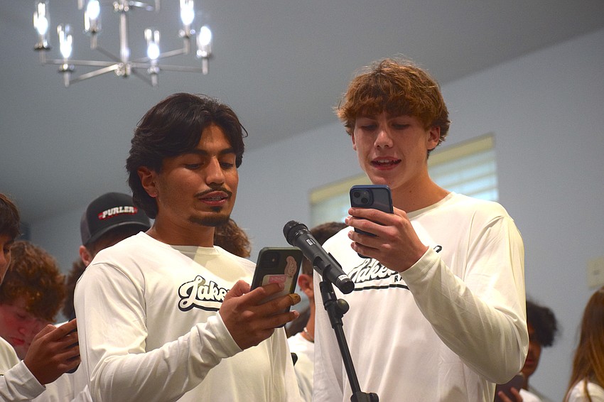 Jeremiah Martinez-Lazo (left) and Cannon Thacker (right) step up to the microphone and lead the way for more than 30 Lakewood Ranch boys wrestlers.
