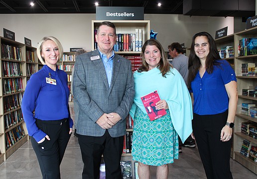 Keera Herbst, Donn Githens, Kim Verreault and Alexa Olivas help celebrate the opening of the new Longboat Key Goodwill bookstore and donation site on Dec. 18.