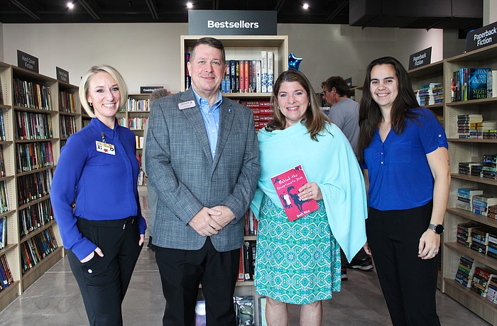 Keera Herbst, Donn Githens, Kim Verreault and Alexa Olivas help celebrate the opening of the new Longboat Key Goodwill bookstore and donation site on Dec. 18.