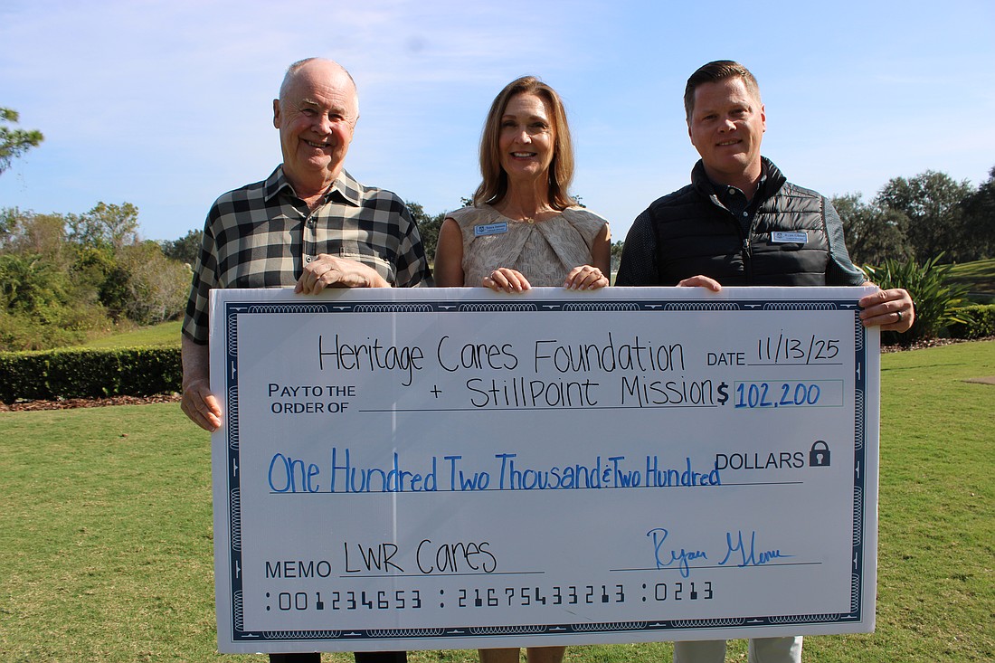 Country Club member Bob Smith, Lifestyle Director Tonya Jansson, and General Manager Ryan Glenn show a check for $102,200 raised through Heritage Cares' Lakewood Ranch Cares — Five Days of Giving initiative.