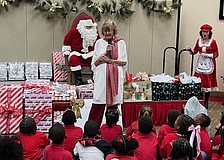Beverly Sutton introduces Santa Claus, who made an appearance at the Reading Buddies Christmas party on Dec. 11 at Christ Church of Longboat Key.