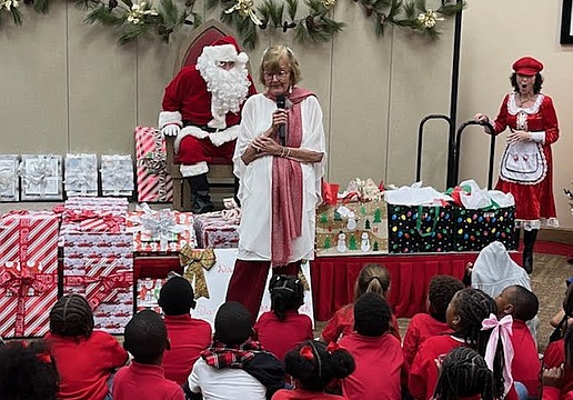 Beverly Sutton introduces Santa Claus, who made an appearance at the Reading Buddies Christmas party on Dec. 11 at Christ Church of Longboat Key.