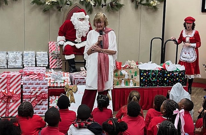 Beverly Sutton introduces Santa Claus, who made an appearance at the Reading Buddies Christmas party on Dec. 11 at Christ Church of Longboat Key.