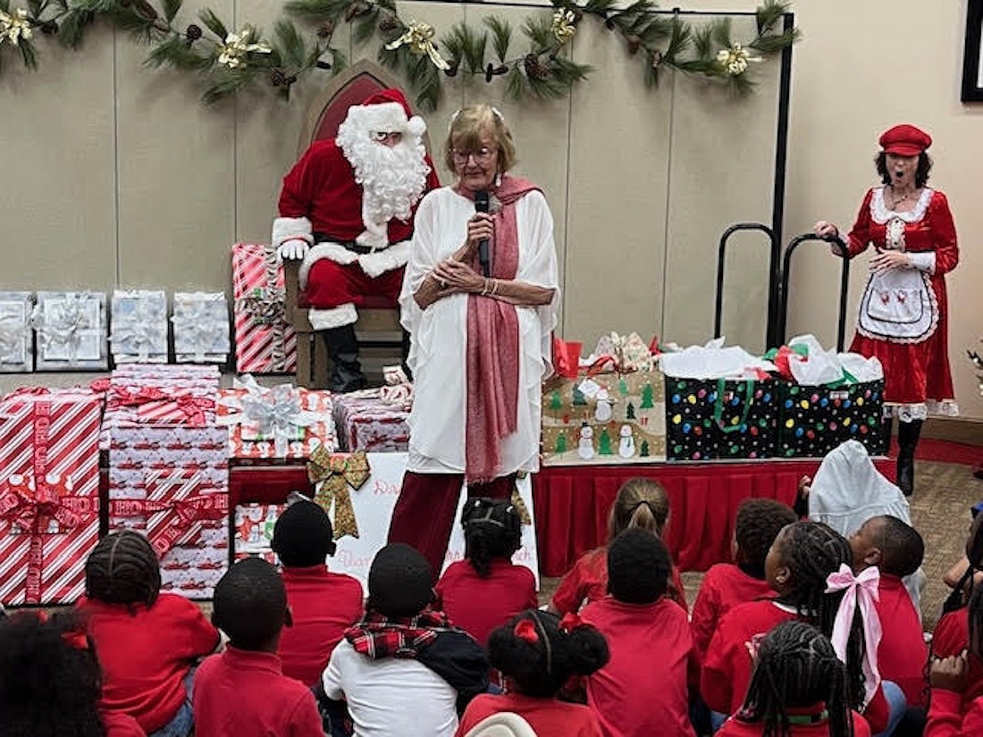 Beverly Sutton introduces Santa Claus, who made an appearance at the Reading Buddies Christmas party on Dec. 11 at Christ Church of Longboat Key.