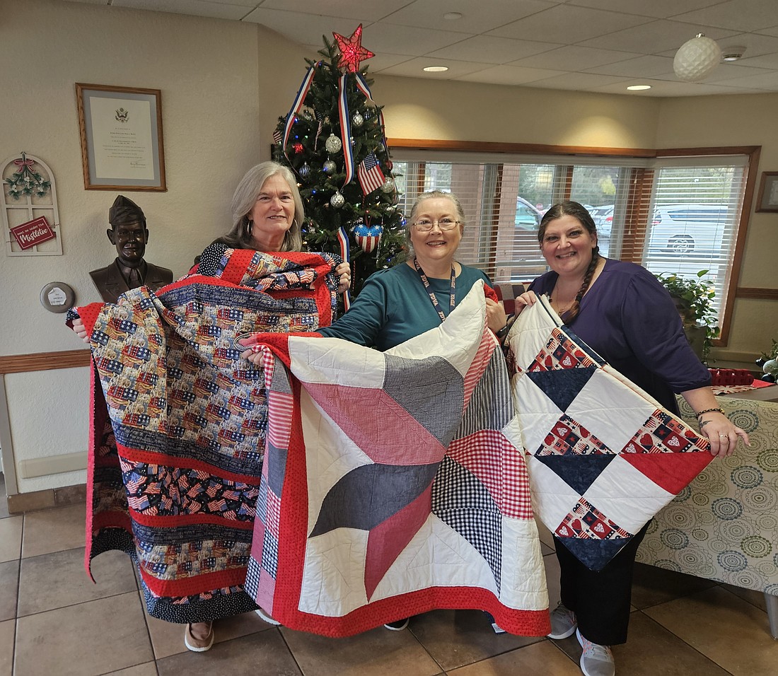 Tamara Pettit (left) presents three handmade quilts to the Emory L. Bennett Veterans’ Nursing Home in Daytona Beach. Courtesy photo