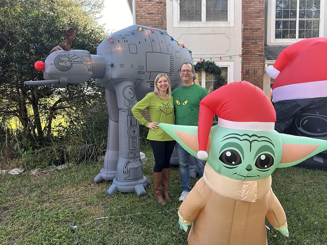 Leah and Tom Fina filled their front yard with inflatables and other decorations that draw families in to see the festive display.