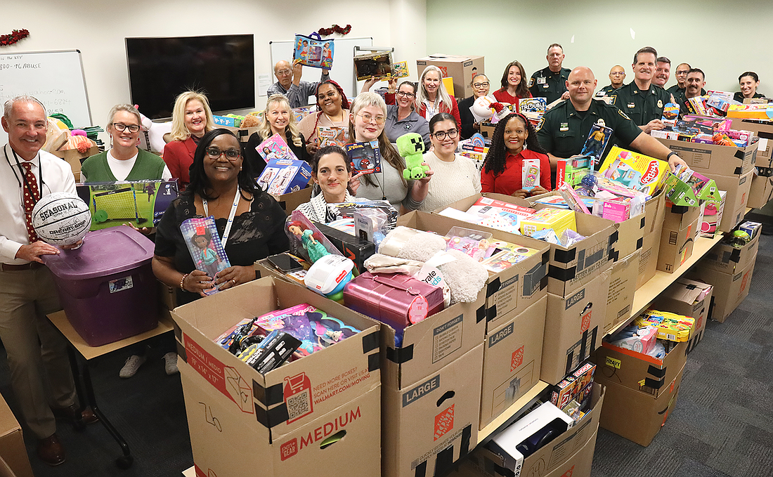 Staff at the 12th Judicial Circuit Guardian Ad Litem program sort through the delivery of presents for children up to 18 years of age.