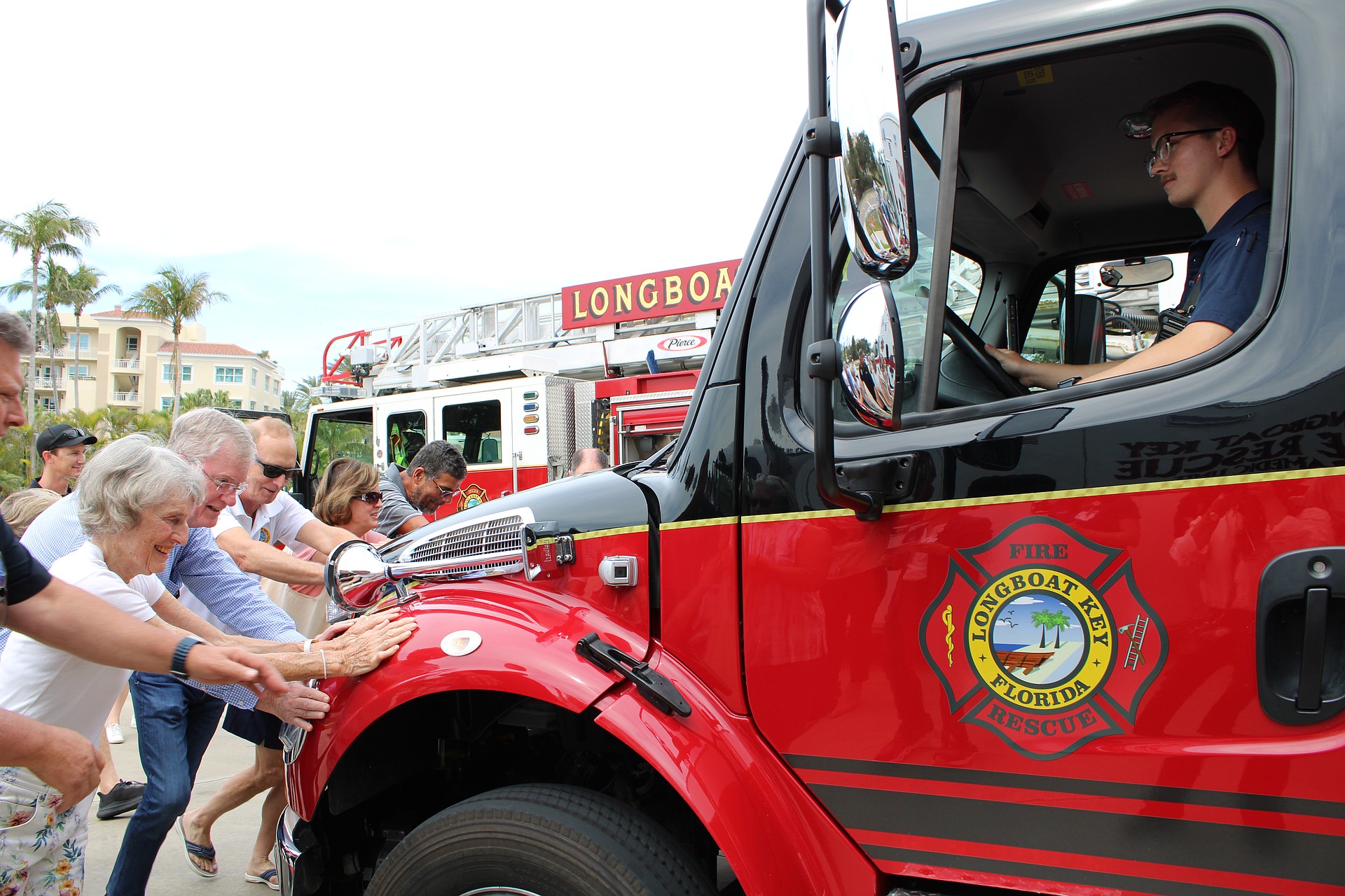 With a hearty collective effort, community members help “push in” the newest fleet addition at Fire Station 92 during a March 25 open house. The public was invited to see the facility, which opened in 2021, as well as check out the station’s new $600,000 ambulance.