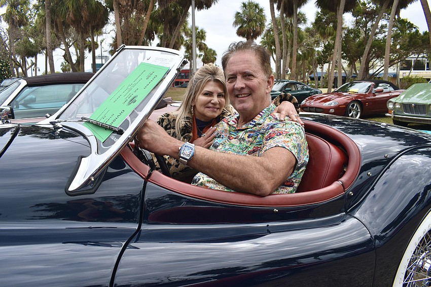 Sarasota's Zack and Greta Hamric sit in their 1956 Jaguar XK 140MC Roadster formerly owned by Hollywood star Michael Douglas and Catherine Zeta-Jones.