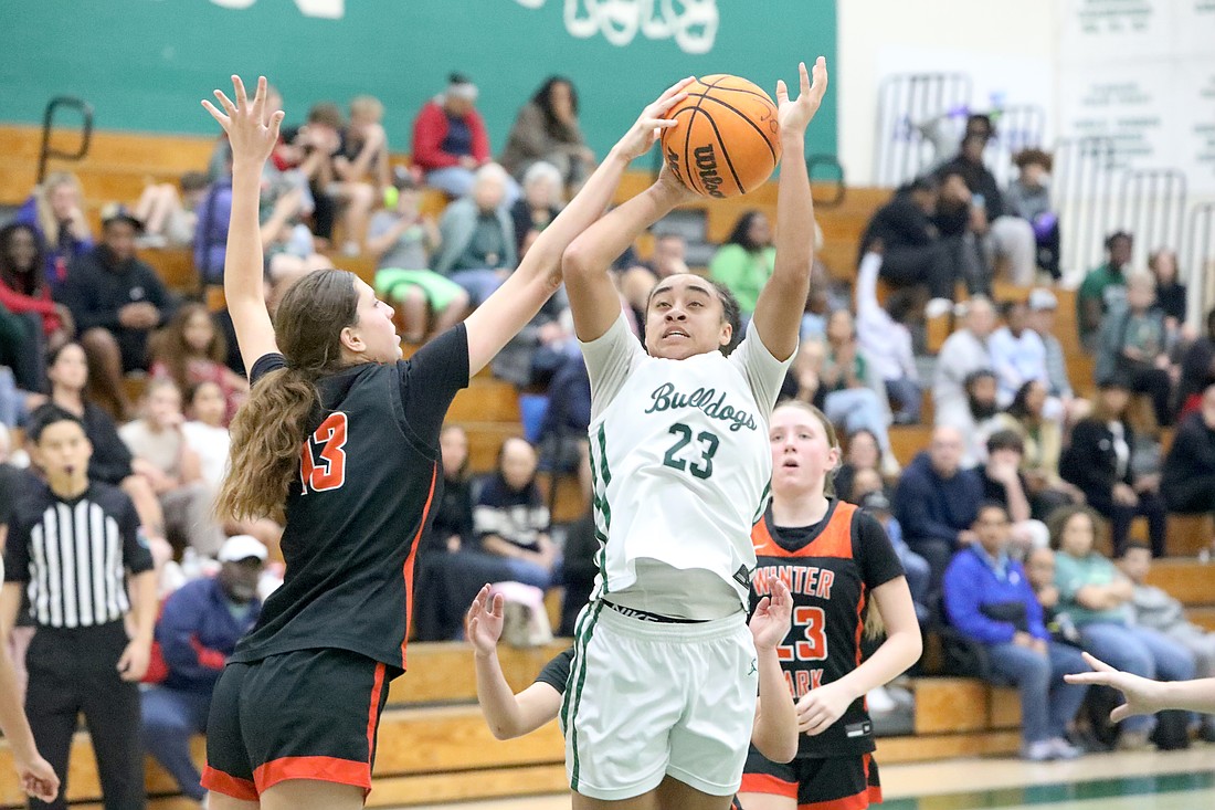 FPC's Lexi Brown (23) puts up a shot against Winter Park's 6-foot-1 center, Elizabeth Riley, on Dec. 23 in the Bulldog Classic. Photo by Brent Woronoff