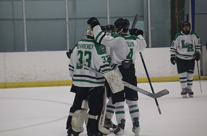 Lakewood Ranch junior goaltender James Devriendt (33) gets some postgame kudos from senior defenseman Jackson Ellis (4). Devriendt's .878 save percentage and 2.05 goals against average through 13 games are both career-best marks on a Mustangs team that has done nothing but win in 2025-26.