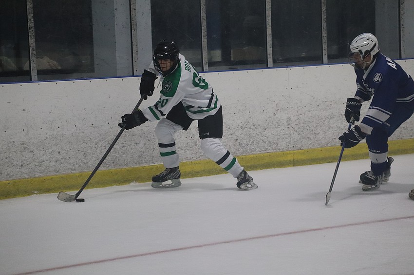 Junior forward Mathy Roy (left) gathers possession of the puck behind Jesuit's net. Like many of his Mustang teammates, he also skates at the club level with Gulf Coast Flames 18UAA in the Statewide Florida Hockey League. Junior forward Mathy Roy (left) gathers possession of the puck behind Jesuit's net. Like many of his Mustang teammates, he also skates at the club level with Gulf Coast Flames 18UAA in the Statewide Florida Hockey League.