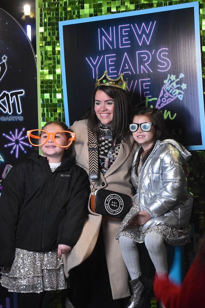 Isabelle Sanchez, 8, Mary Gruber and Sophia Sanchez, 6, traveled from Weston to ring in the new year.