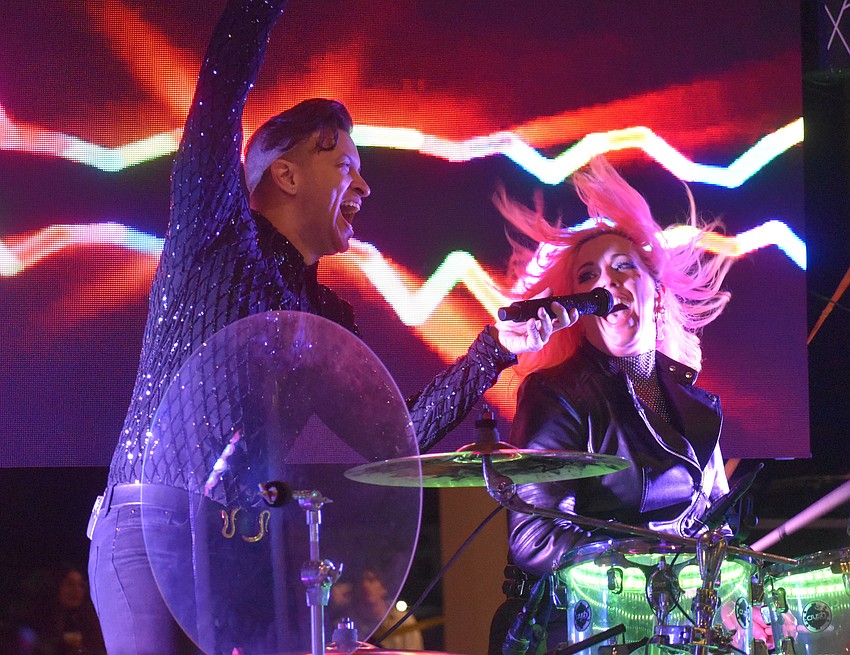 No Filter's Chaz Robinson holds a microphone for Natalie Mustang to sing the song 