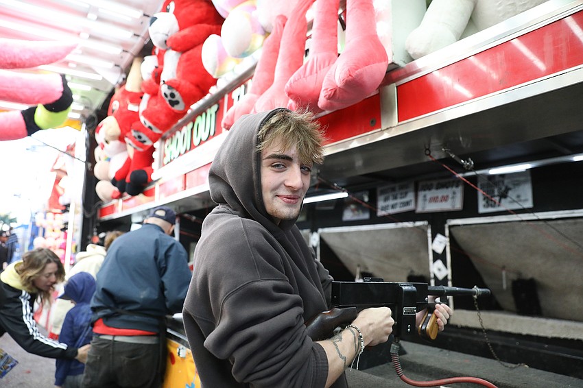 Logan Hardle from Pittsburgh, sharp shoots at paper targets to win oversized stuffed animals.