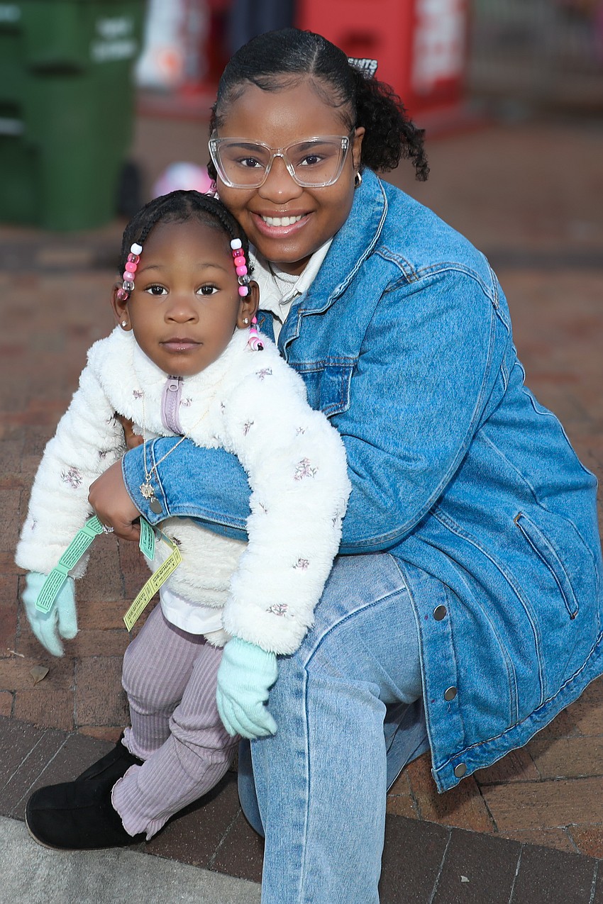 Great Aunt Cireya Deveaux has a pocketful of ride tickets for great-niece, Armaruria Taylor, 3.