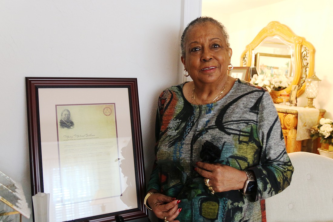 Daisy Grimes holds a black rose in her Ormond Beach home, a tribute to Dr. Mary McLeod Bethune's legacy in Volusia County. Photo by Jarleene Almenas