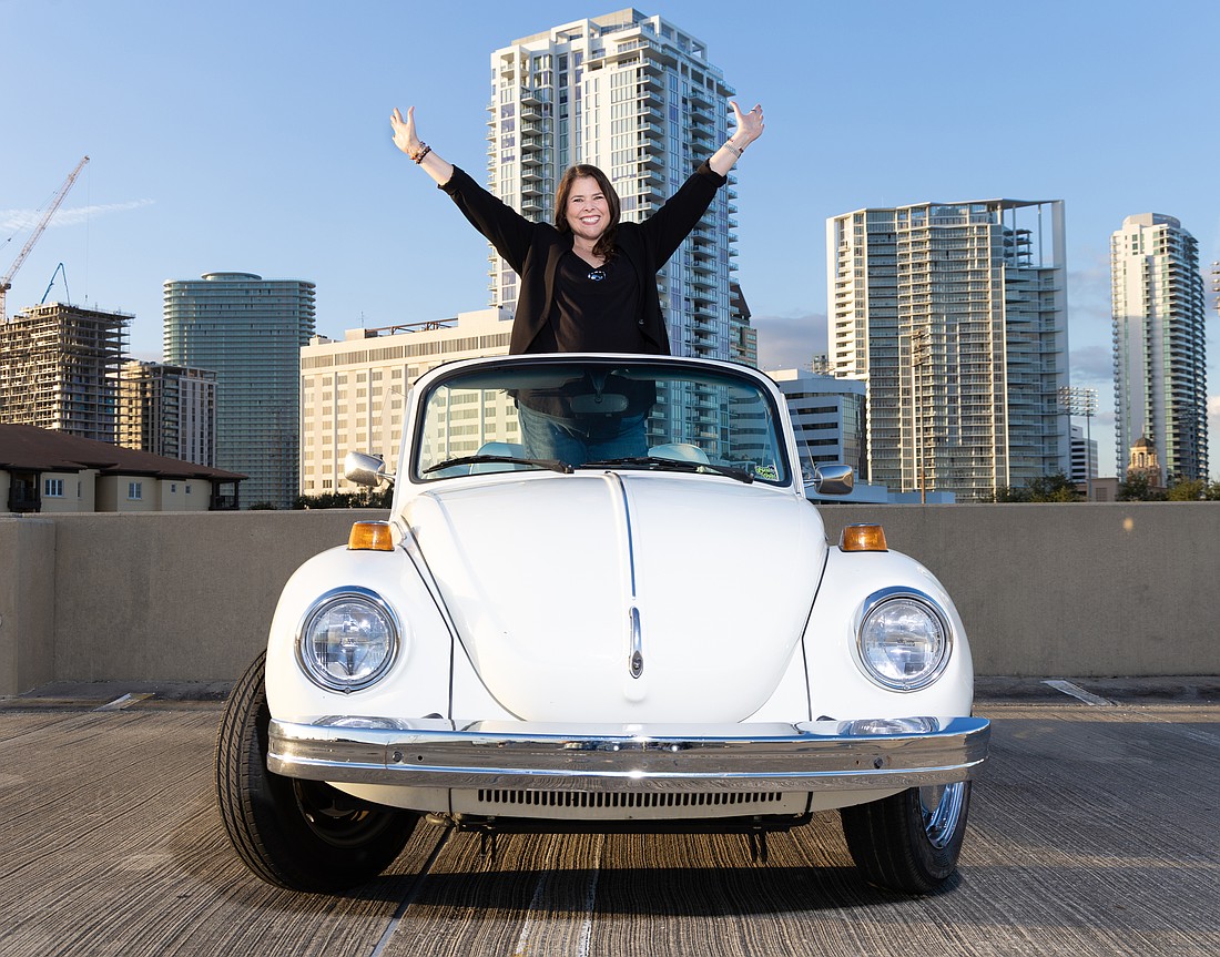 Ginger Galloway, founder of Pinstripe Marketing & Interactive, poses in her 1978 Volkswagen Beetle convertible named Blanche.