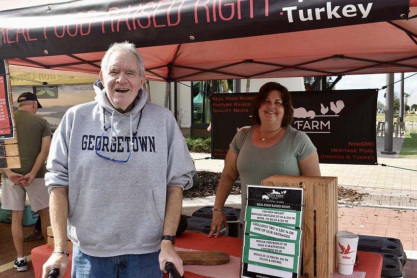 Lakewood Ranch's Mark Theobald stops by the Red's Farm stand to chat with Julie Richie.
