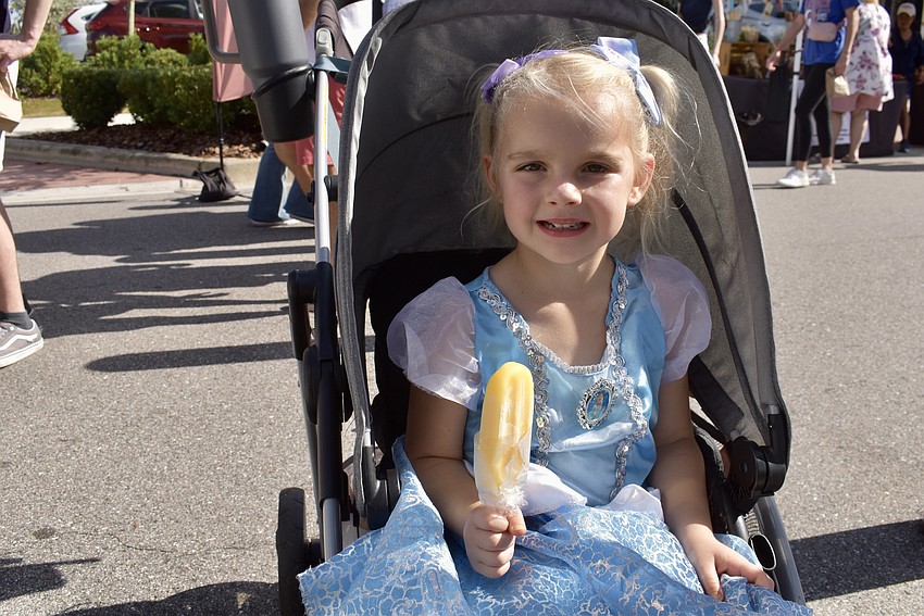 Lakewood Ranch's 4-year-old Rylynn Pitcher eats a mango ice pop from Florida Pops.