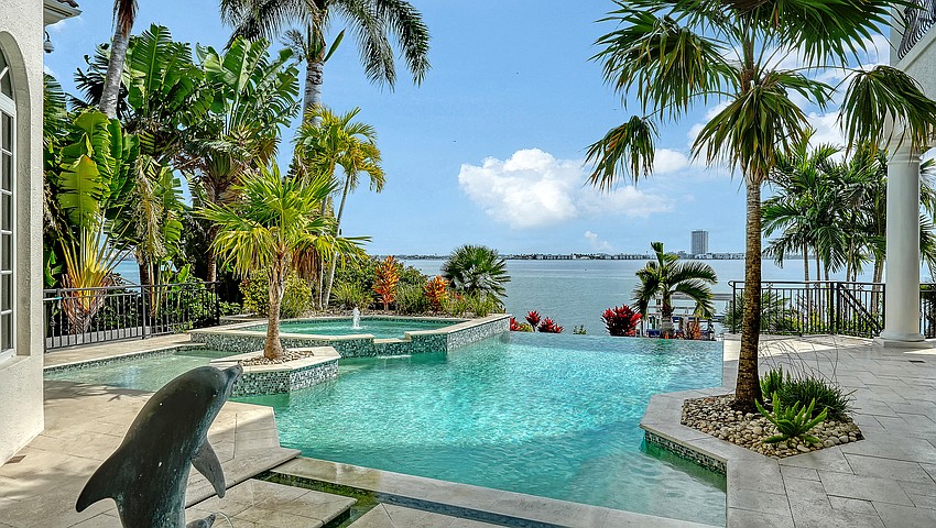 A dolphin statue adds a touch of whimsy to the waterfront view.