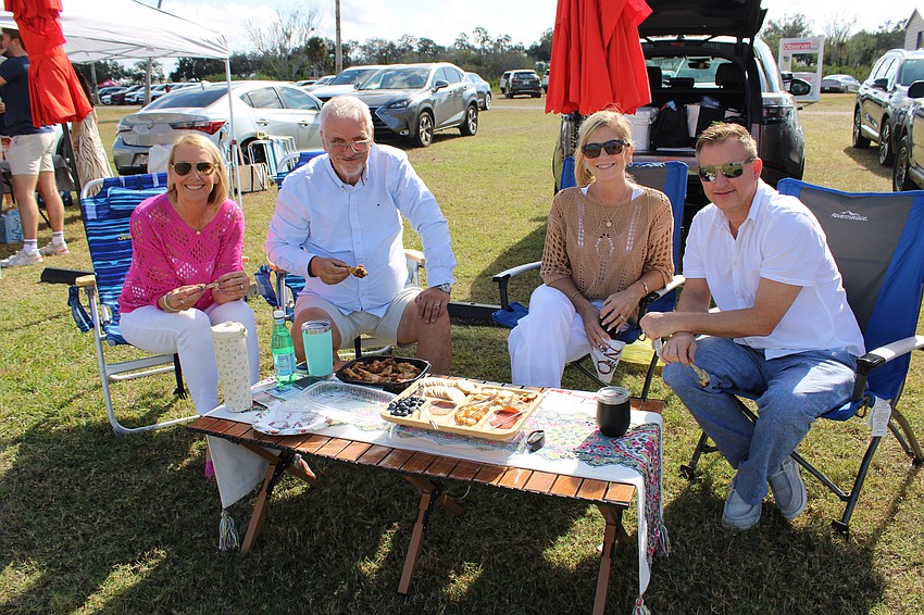Palmetto's Andrea Lee, Mark Barclay, Betsy Woodman and Bryan Woodman devour the chicken wings they brought for their tailgate at the Sarasota Polo Club.