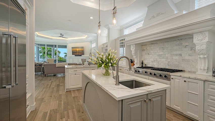 Italian flooring runs throughout the home, including the gourmet chef’s kitchen.