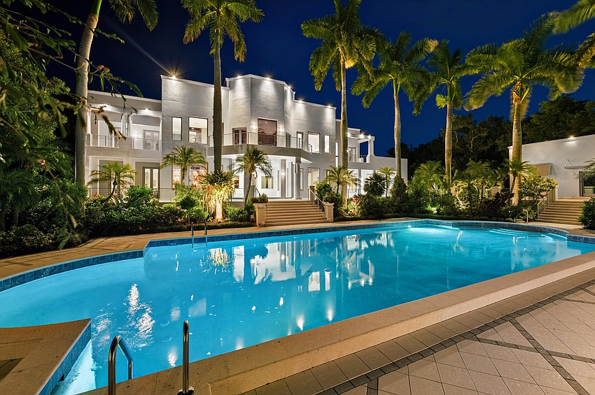 A pool house and guest house come with the 2.4-acre property, in addition to a tennis court.