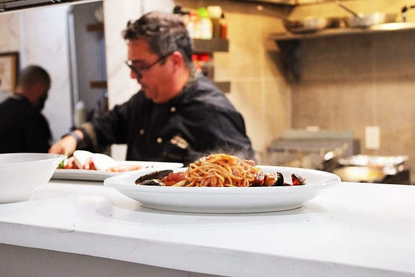 A steaming plate of pasta comes up to the pass while Simone Salustri, owner of the newly reopened Nōnnō Umberto restaurant, begins work on another dish.