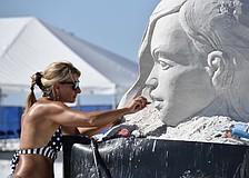 Angese Rudzite Kirillova works on "Playground" during the 2025 Siesta Key Crystal Classic Sandsculpting Festival.