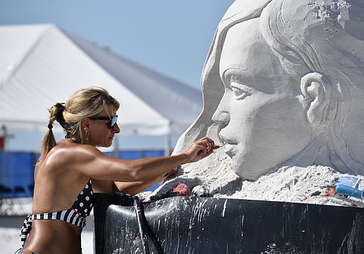 Angese Rudzite Kirillova works on "Playground" during the 2025 Siesta Key Crystal Classic Sandsculpting Festival.