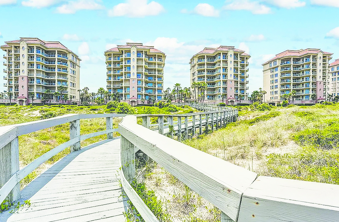 Oceanfront condominium features four bedrooms, three full and one half-bathrooms, balconies, community pools and two garage spaces.