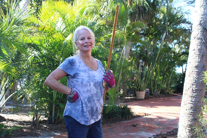 Linda Crouse said she was happy to spend a few hours giving back to the community by helping rake wood chips, clear debris from 