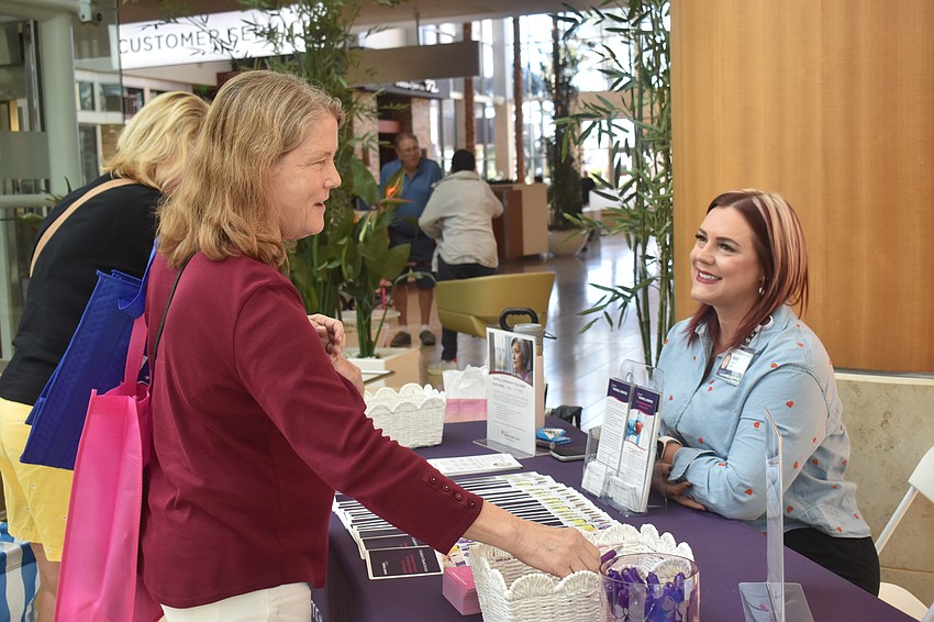 Lakewood Ranch's Caryn Roelofs learns about Empath Tidewell Hospice from  Amy Jones, who works as a professional relations liaison for teh company.