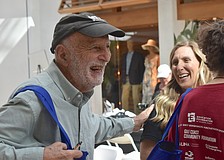 Sarasota's Hasan Tezduyar gives a pat of appreciation to Rachel Apple, a wellness associate with Qualliv, at the Health and Wellness Expo at The Mall at University Town Center.