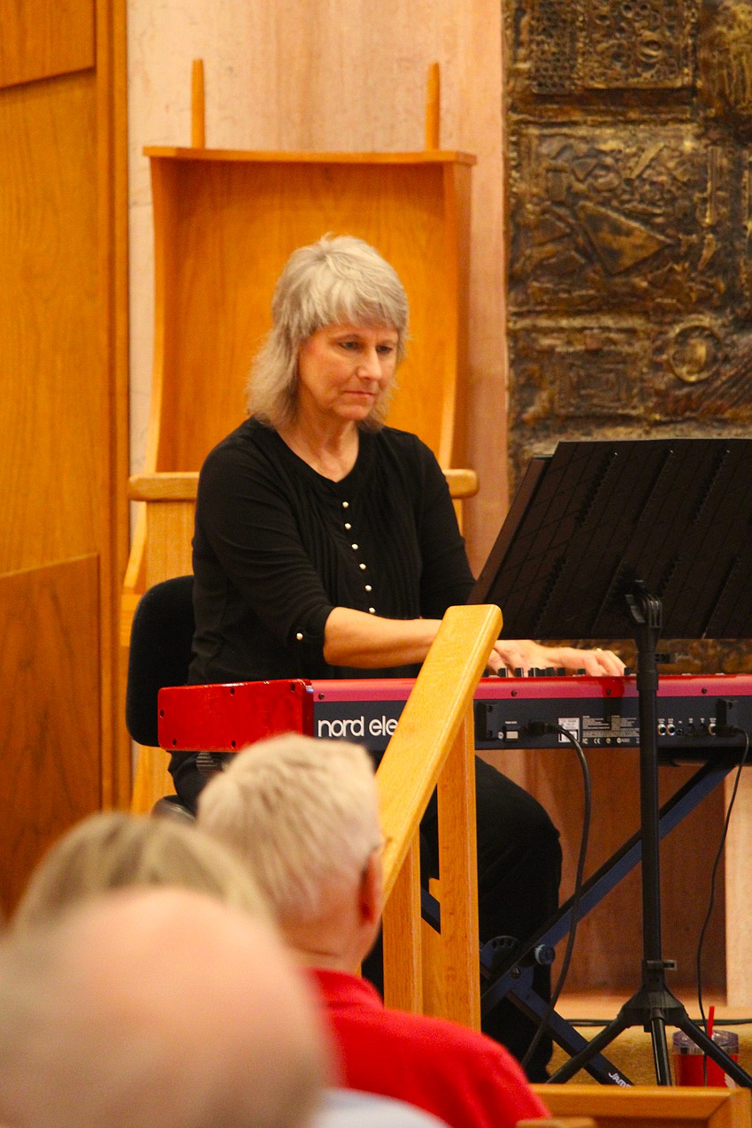 Pianist Judi Glover locks in while playing the fast-paced style of klezmer music the Yiddish Cowboys band is known for performing.