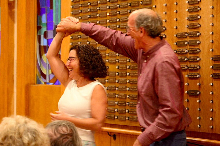 Steve Schwartz gives Felice Marcus a spin while the Yiddish Cowboys play an upbeat tune at The Education Center.