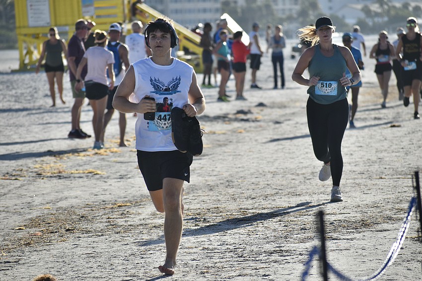 Gianni Vetri and Danielle Haarer race across the sands.