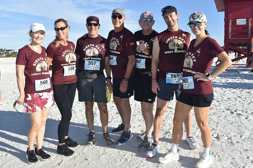 Kathy Hargreaves, Debra Riva, Charlie Roberts, John Hargreaves, Russa Vega, Kevin McQuaid and Samantha Wirks gather on the beach.
