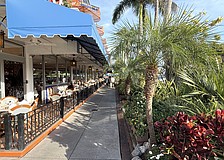 All appears back to normal in some areas of St. Armands Circle, such as the sidewalk and landscaping aside Columbia Restaurant. Many storefronts, however, remain vacant 15 months after Hurricane Milton.