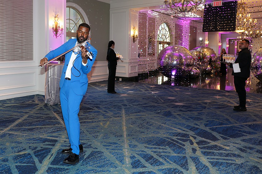 Laron Hearst strolls the cocktail party with his electric violin.